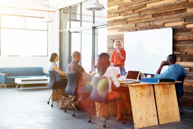 Shot of a female office worker giving a financial presentation to her colleagues